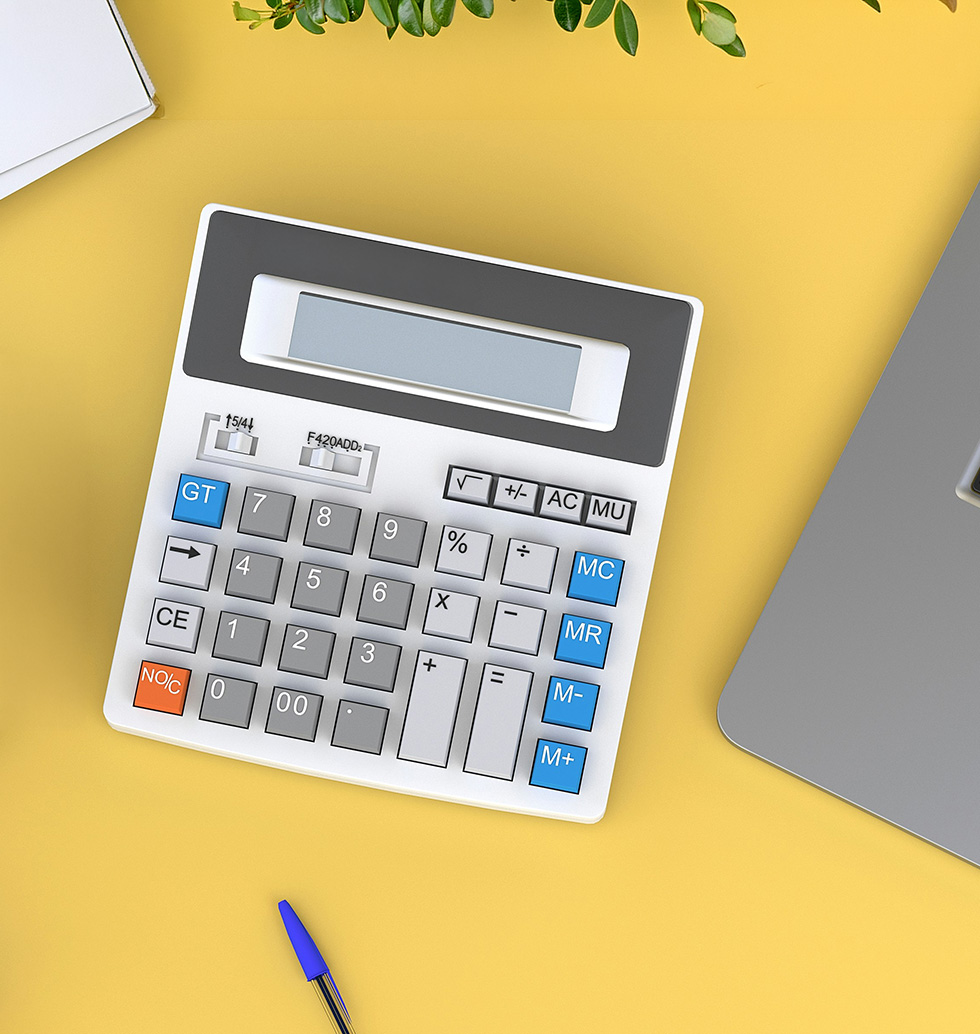Calculator and laptop on a desk