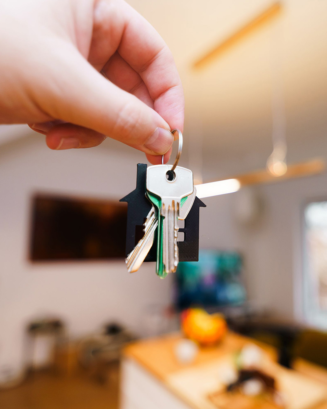 Holding house keys in front of a front door