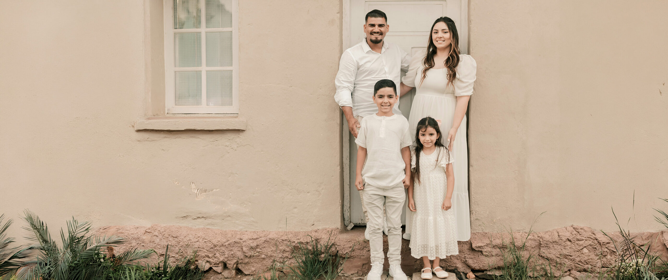 Family standing in front of their home